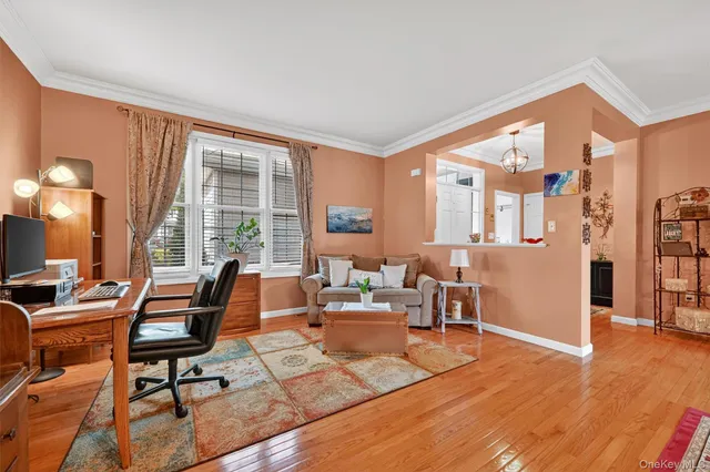 a living room with furniture and large windows