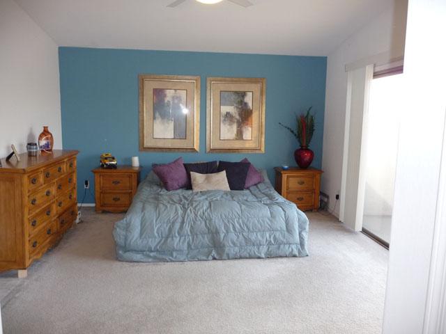 2416 West Carter Road Phoenix, AZ 85041 - Photo 15 of 32 a spacious bedroom with a bed and window