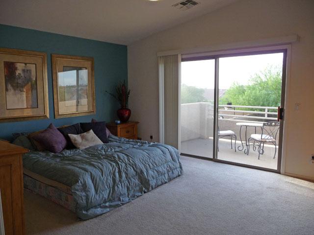 2416 West Carter Road Phoenix, AZ 85041 - Photo 16 of 32 a bedroom with a bed lamp and large window