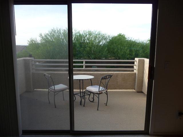 2416 West Carter Road Phoenix, AZ 85041 - Photo 17 of 32 a balcony with table and chairs