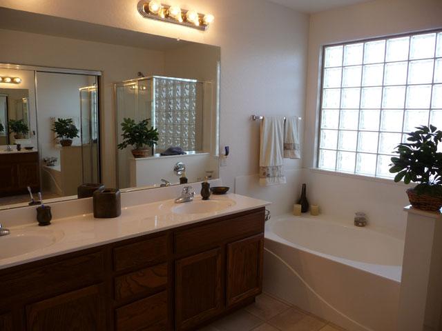 2416 West Carter Road Phoenix, AZ 85041 - Photo 20 of 32 a bathroom with a tub double sink window and mirror