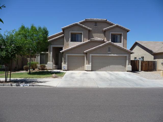 2416 West Carter Road Phoenix, AZ 85041 - Photo 2 of 32 a front view of a house with a yard and garage