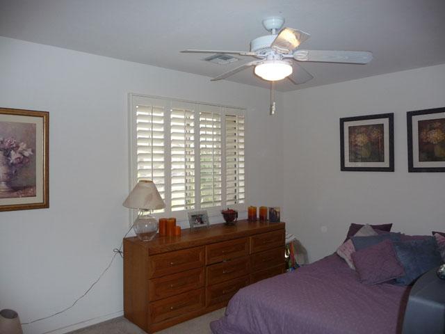 2416 West Carter Road Phoenix, AZ 85041 - Photo 24 of 32 a bed room with a bed and a chandelier