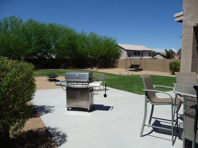 2416 West Carter Road Phoenix, AZ 85041 - Photo 7 of 32 a view of a patio with table and chairs with a garden