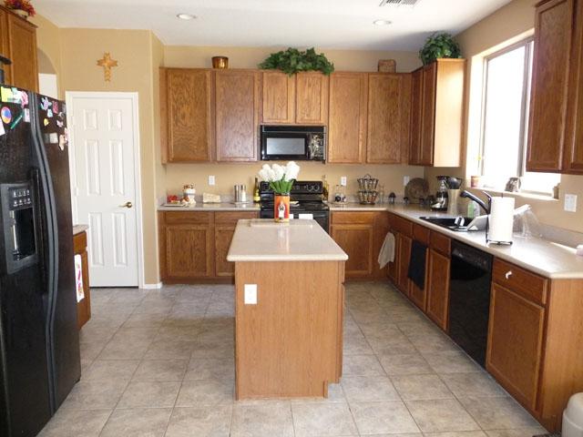 2416 West Carter Road Phoenix, AZ 85041 - Photo 8 of 32 a kitchen with a sink a stove and refrigerator