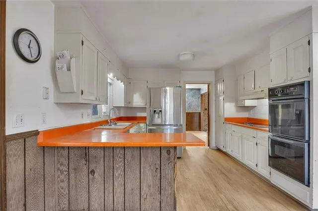 an empty room with windows and wooden floor