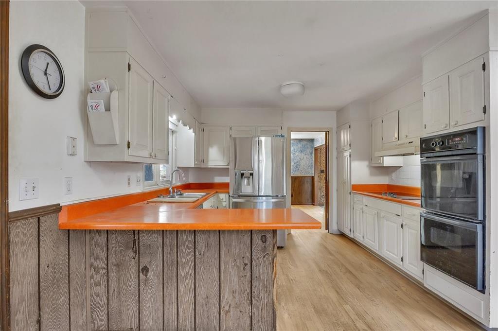 1113 Honeysuckle Drive Canton, GA 30114 - Photo 11 of 57 a kitchen with stainless steel appliances granite countertop a stove a sink and a refrigerator