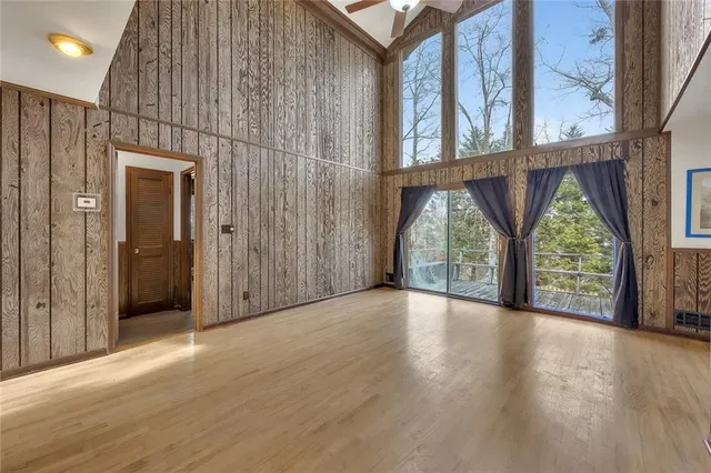 a view of a porch with wooden floor and windows