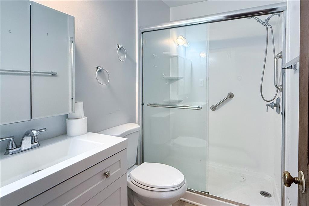 1113 Honeysuckle Drive Canton, GA 30114 - Photo 24 of 57 a bathroom with a sink a toilet and shower