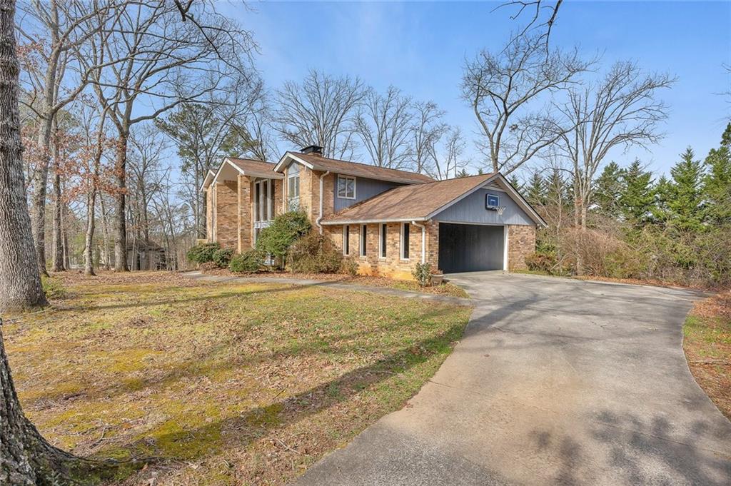 1113 Honeysuckle Drive Canton, GA 30114 - Photo 3 of 57 a front view of a house with a yard and garage