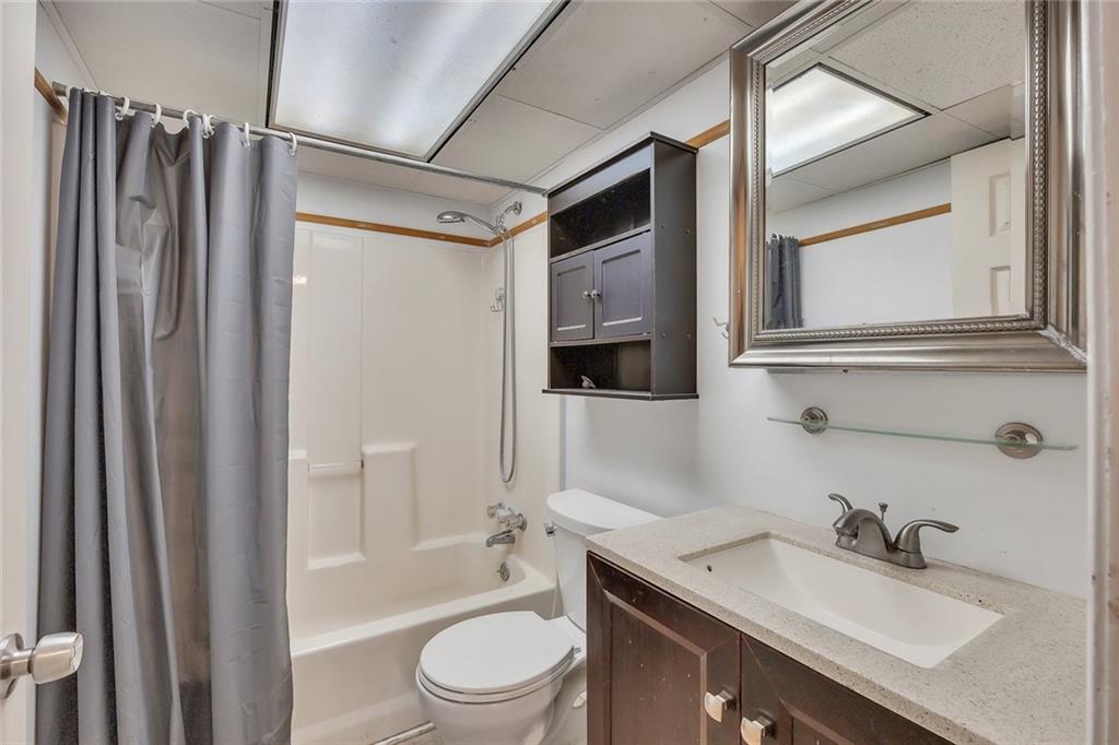 1113 Honeysuckle Drive Canton, GA 30114 - Photo 44 of 57 a bathroom with a granite countertop sink toilet and shower