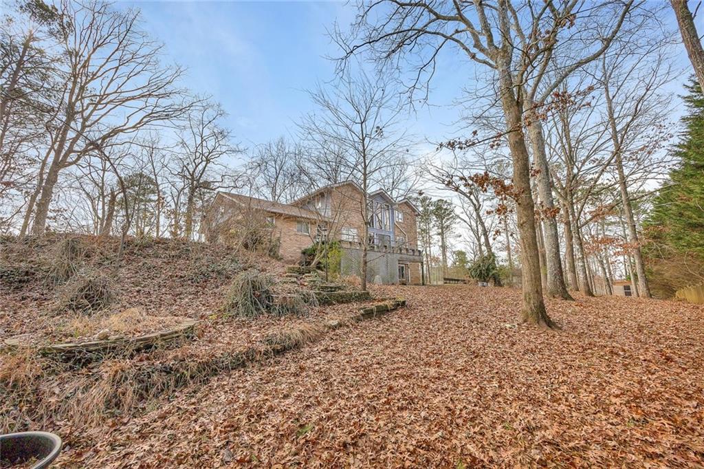 1113 Honeysuckle Drive Canton, GA 30114 - Photo 50 of 57 a backyard of a house with large trees