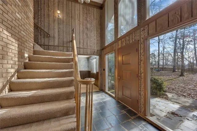 a view of a balcony with wooden floor and door