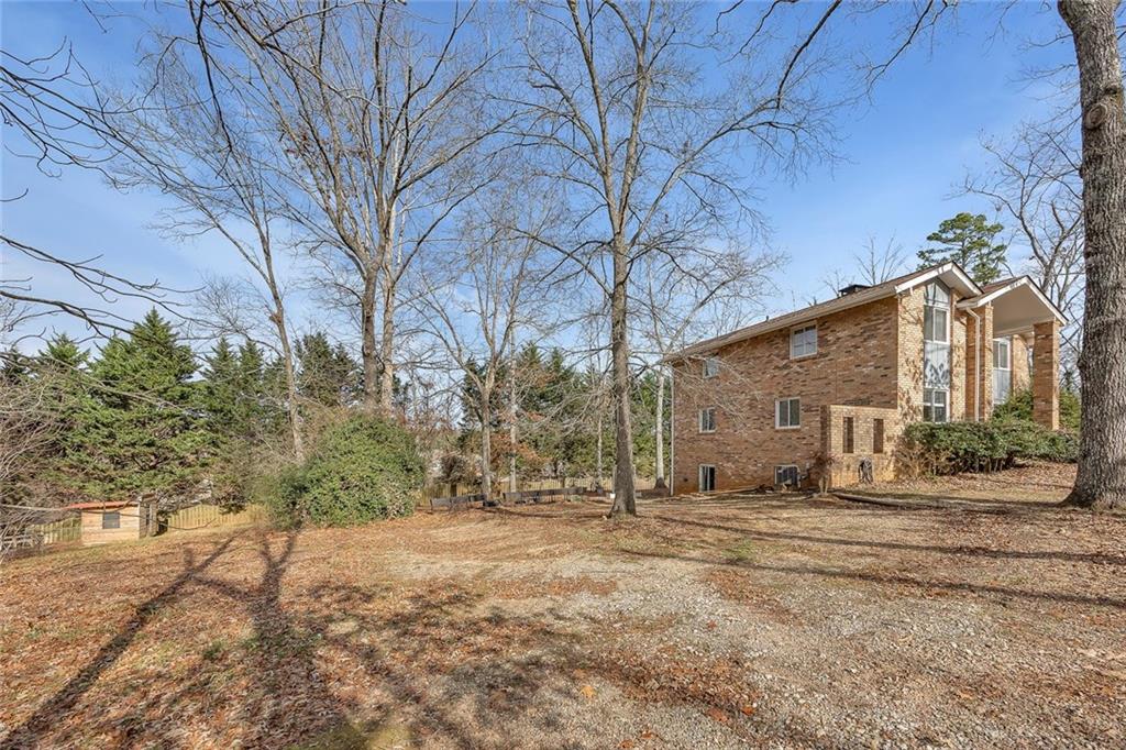 1113 Honeysuckle Drive Canton, GA 30114 - Photo 52 of 57 a backyard of a house with large trees