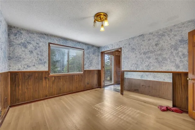 a kitchen with stainless steel appliances granite countertop a refrigerator a stove and white cabinets