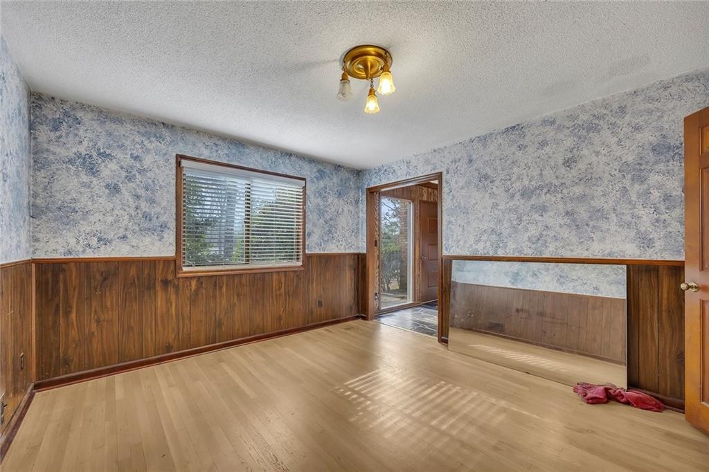 1113 Honeysuckle Drive Canton, GA 30114 - Photo 8 of 57 a view of an empty room with wooden floor and a window