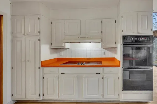 a kitchen with stainless steel appliances granite countertop a refrigerator a stove and a sink