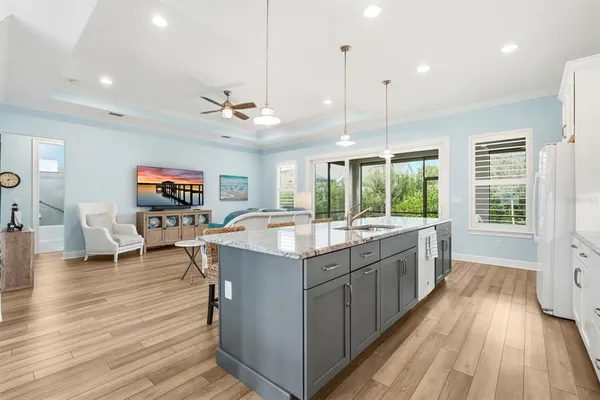 a kitchen with a stove and a wooden floor