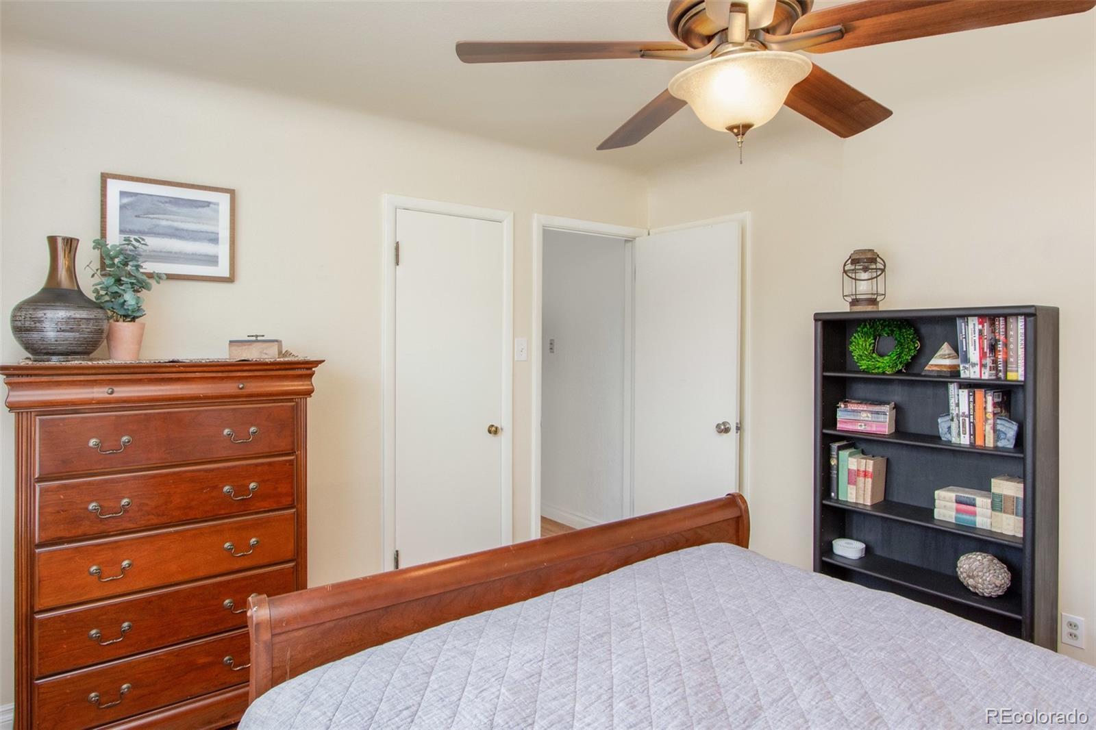 1635 Montview Road Greeley, CO 80631 - Photo 16 of 25 a bedroom with a dresser and a book shelf