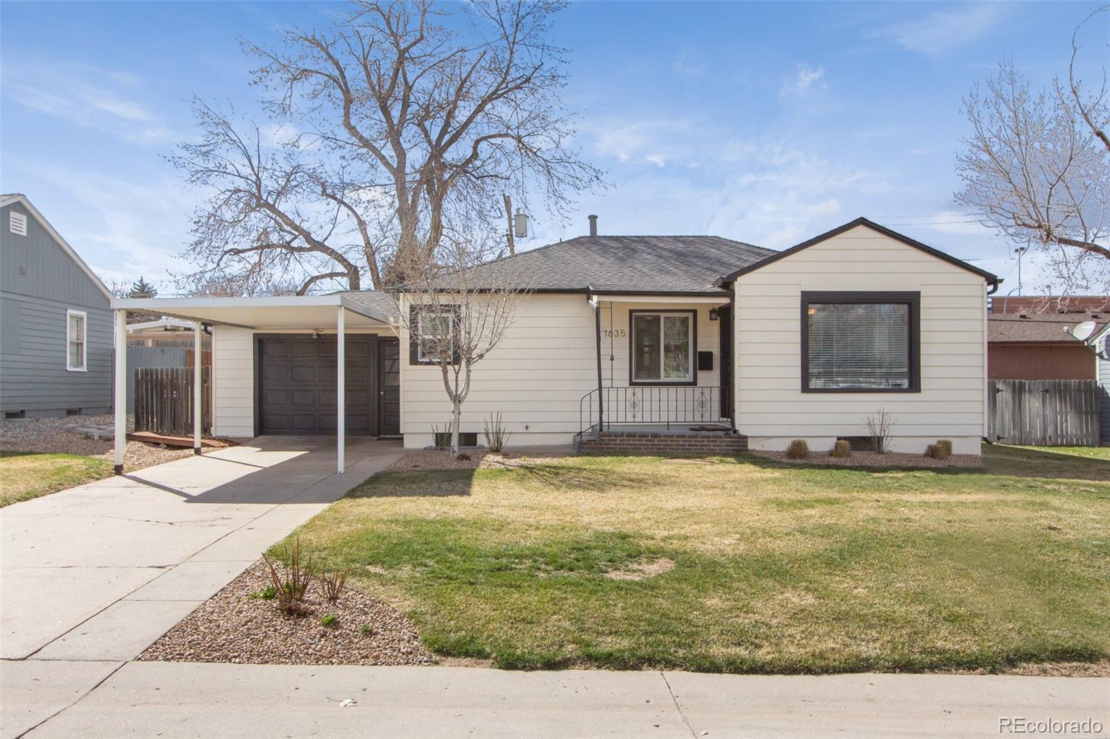 1635 Montview Road Greeley, CO 80631 - Photo 2 of 25 a backyard of a house with table and chairs
