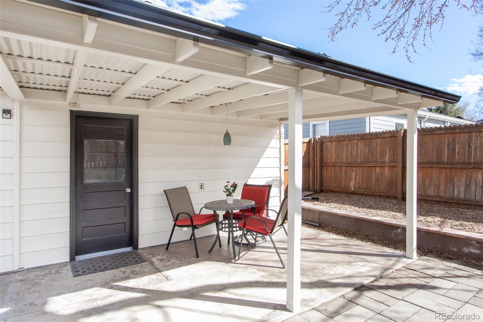 1635 Montview Road Greeley, CO 80631 - Photo 25 of 25 a view of a porch with a table and chairs and iron fence