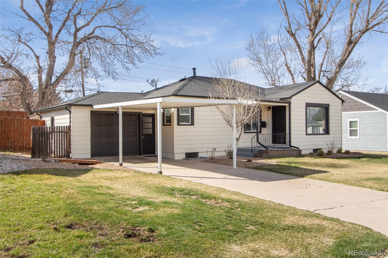1635 Montview Road Greeley, CO 80631 - Photo 3 of 25 a front view of a house with a yard and garage