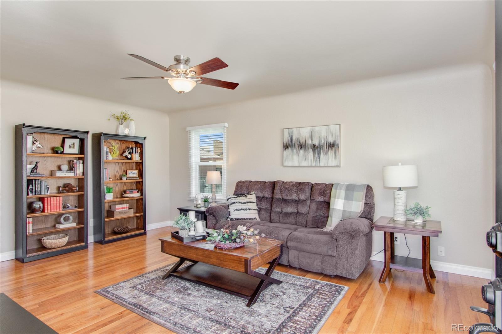 1635 Montview Road Greeley, CO 80631 - Photo 4 of 25 a living room with furniture and wooden floor