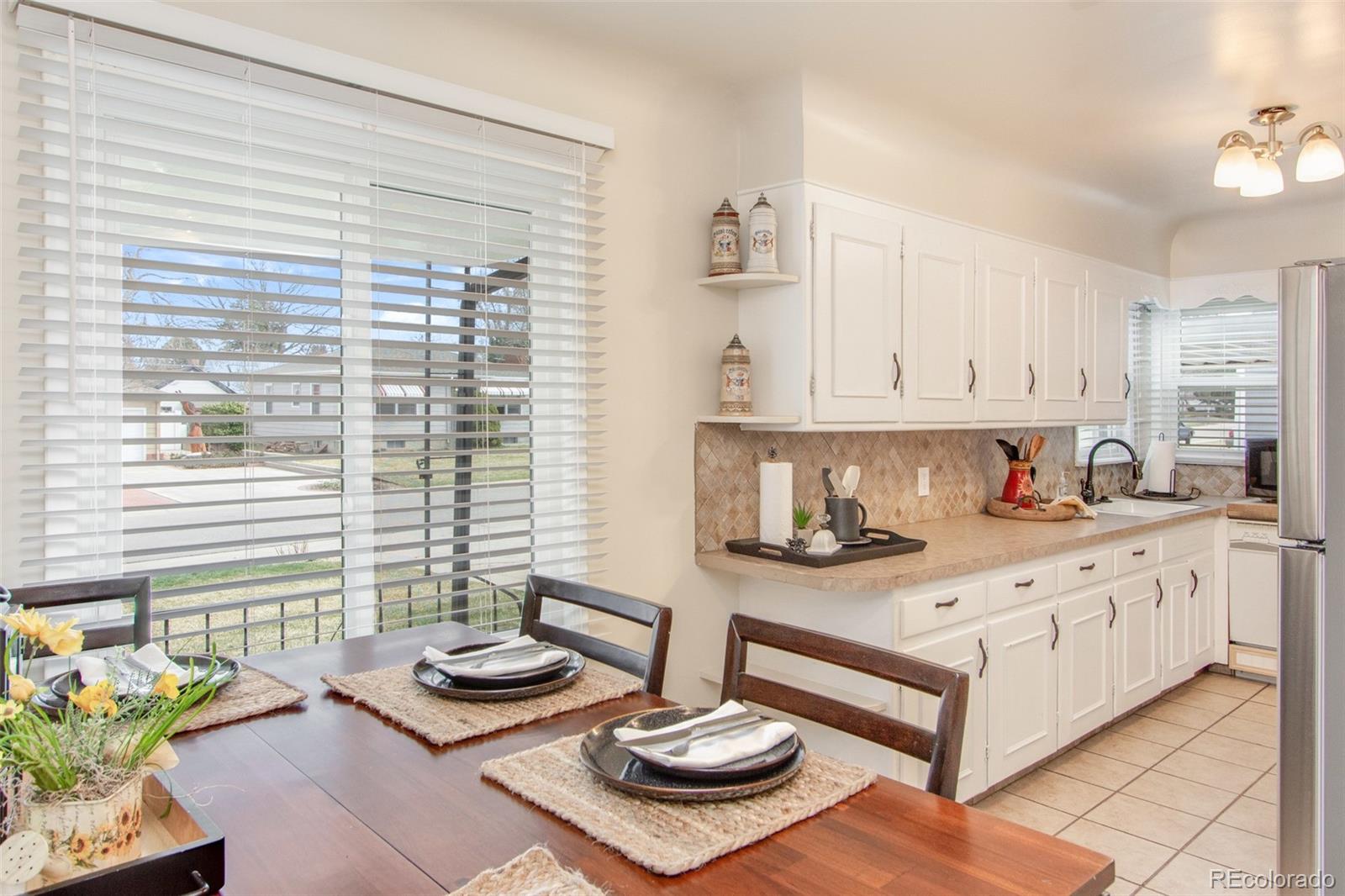 1635 Montview Road Greeley, CO 80631 - Photo 7 of 25 a kitchen with stainless steel appliances kitchen island granite countertop a stove and white cabinets