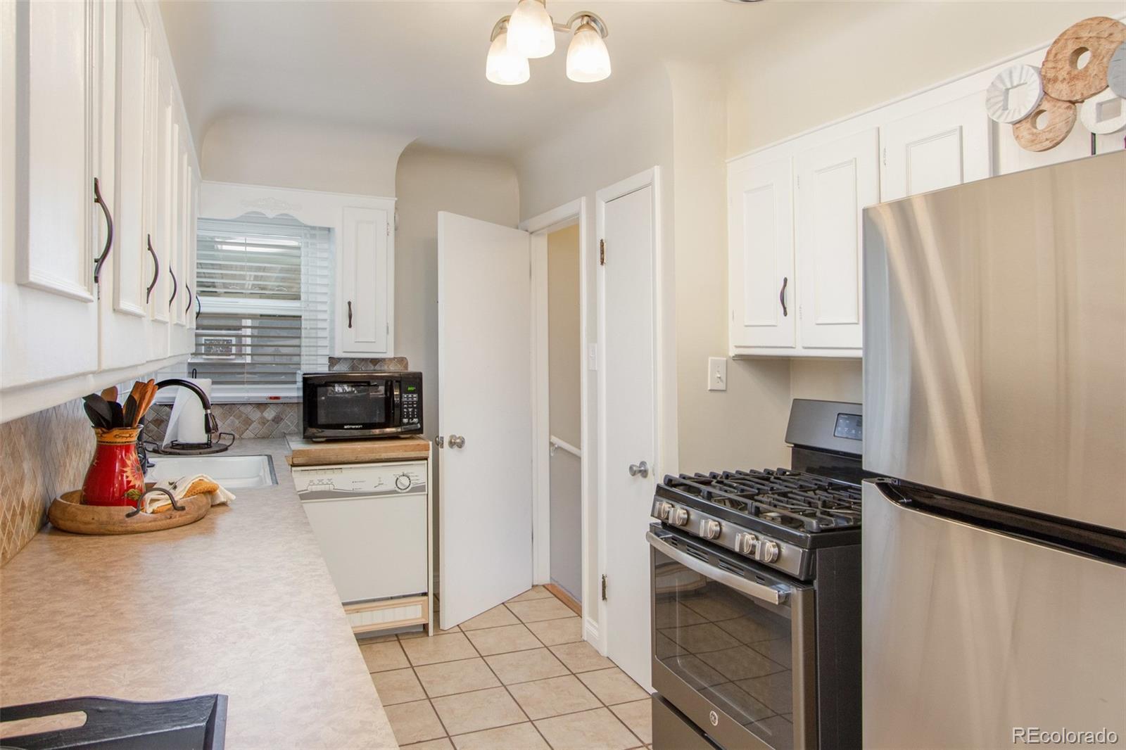 1635 Montview Road Greeley, CO 80631 - Photo 8 of 25 a kitchen with stainless steel appliances a refrigerator sink and stove