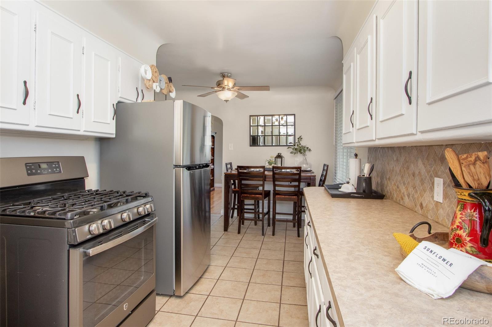 1635 Montview Road Greeley, CO 80631 - Photo 9 of 25 a kitchen with stainless steel appliances granite countertop a sink stove and refrigerator