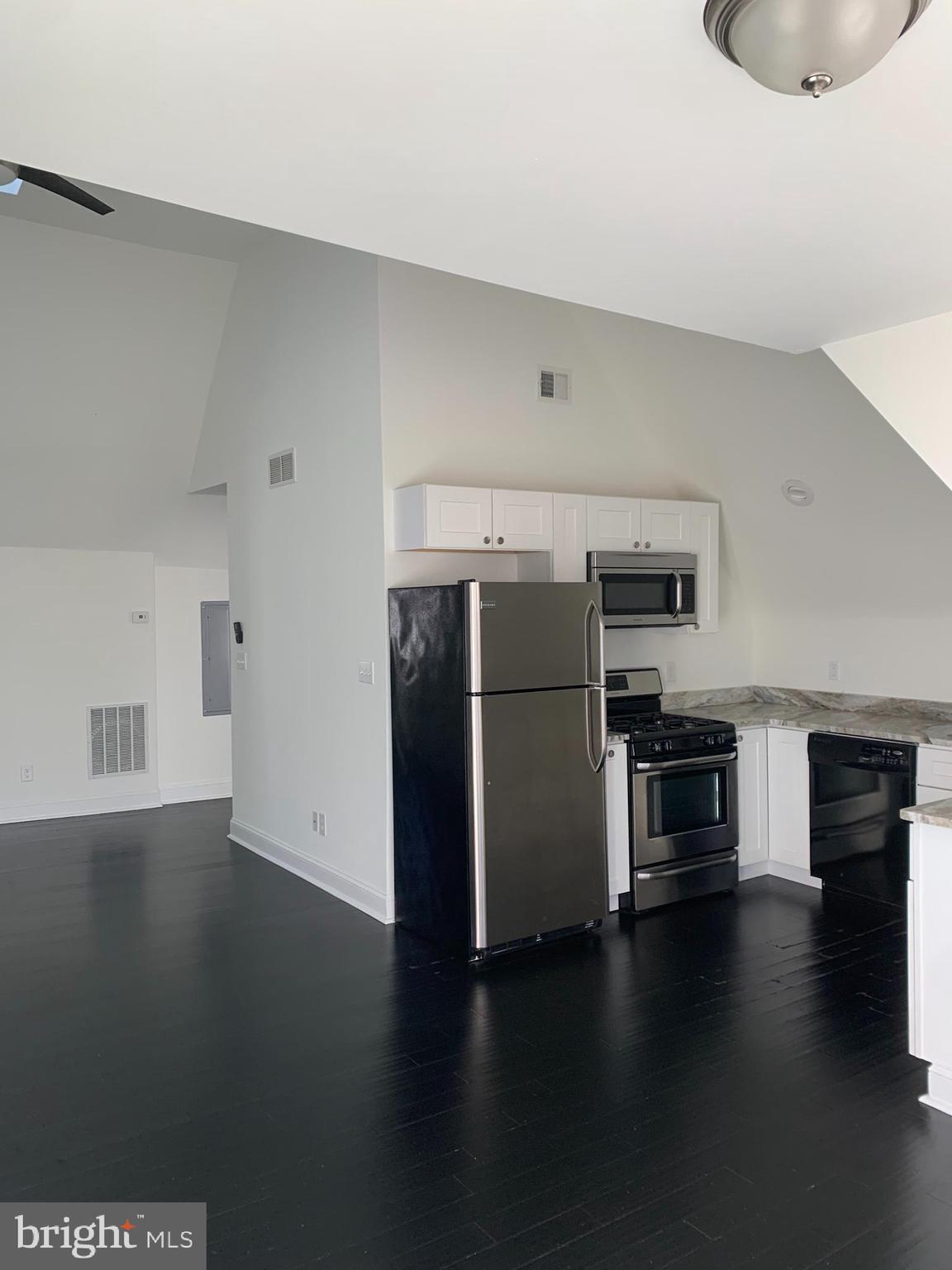 35 Windermere Avenue Lansdowne, PA 19050 - Photo 5 of 13 a kitchen with stainless steel appliances a refrigerator and a stove top oven