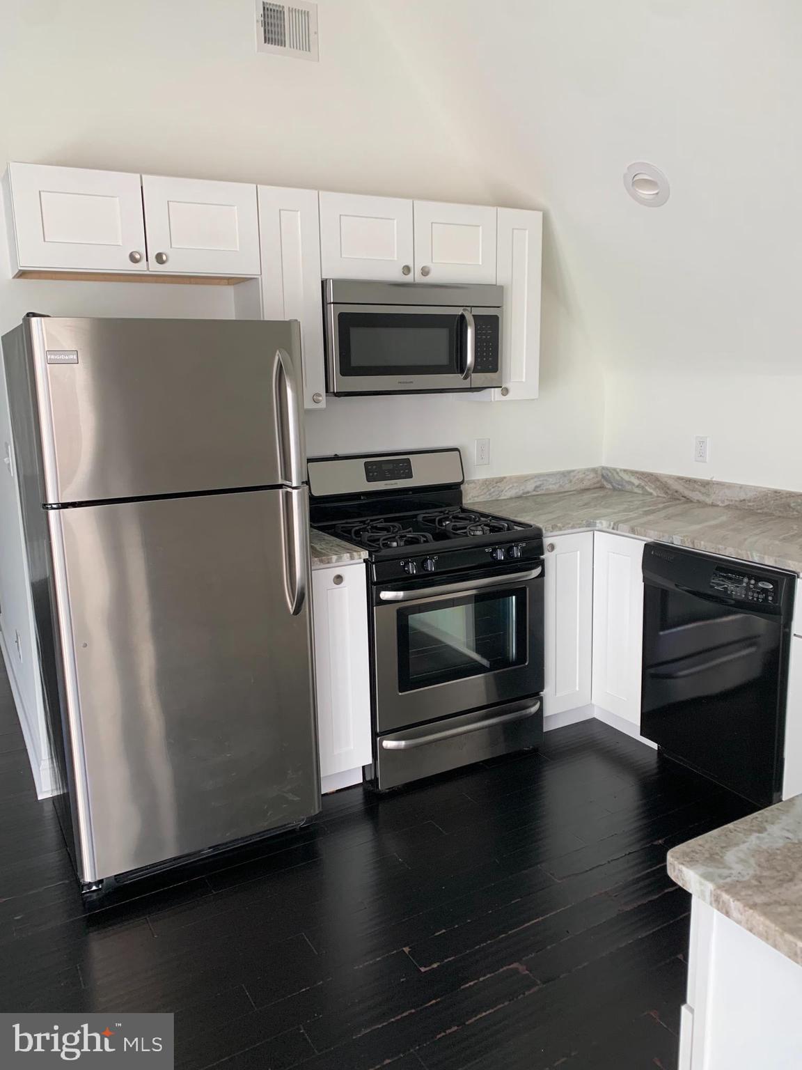 35 Windermere Avenue Lansdowne, PA 19050 - Photo 6 of 13 a kitchen with appliances and wooden floor