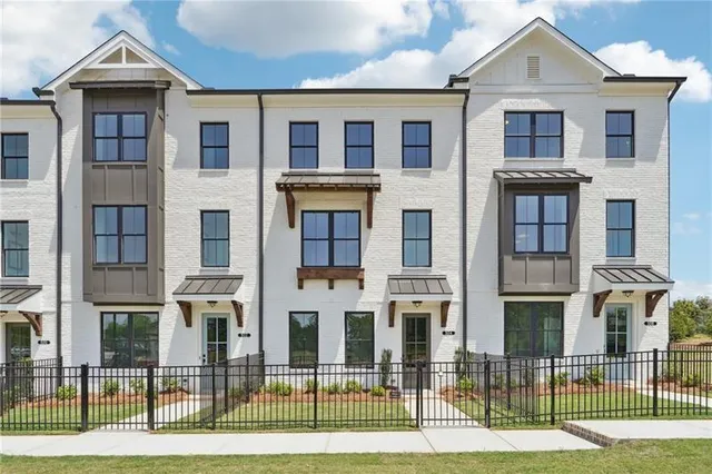 a view of a brick house with many windows