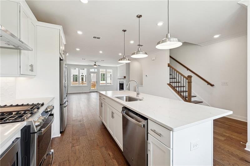 504 Healy Drive Cumming, GA 30040 - Photo 14 of 25 a kitchen with kitchen island a sink and stove