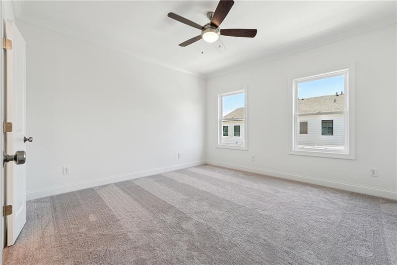 504 Healy Drive Cumming, GA 30040 - Photo 18 of 25 an empty room with windows and fan