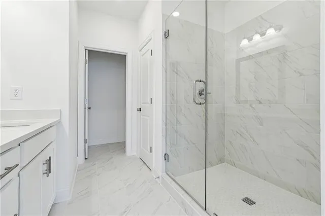 a bathroom with a shower and a sink