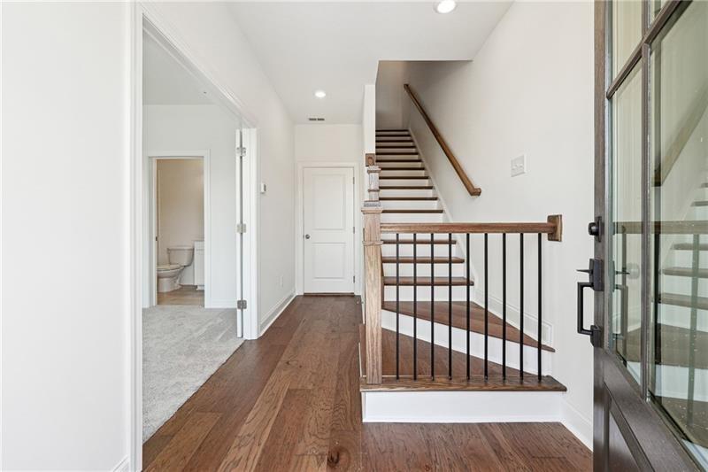504 Healy Drive Cumming, GA 30040 - Photo 2 of 25 a view of a hallway with wooden floor and stairs