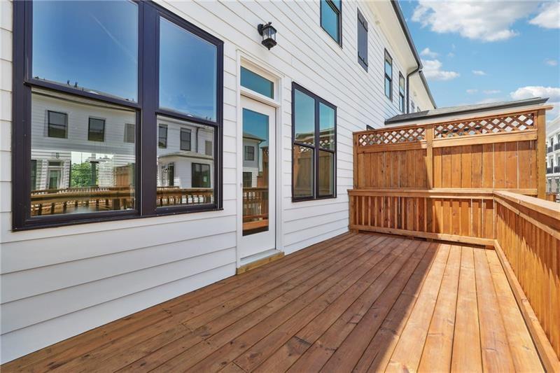 504 Healy Drive Cumming, GA 30040 - Photo 24 of 25 a view of a balcony with wooden floor and fence