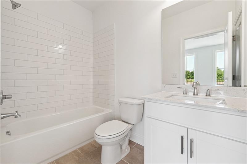 504 Healy Drive Cumming, GA 30040 - Photo 5 of 25 a bathroom with a sink a toilet and shower
