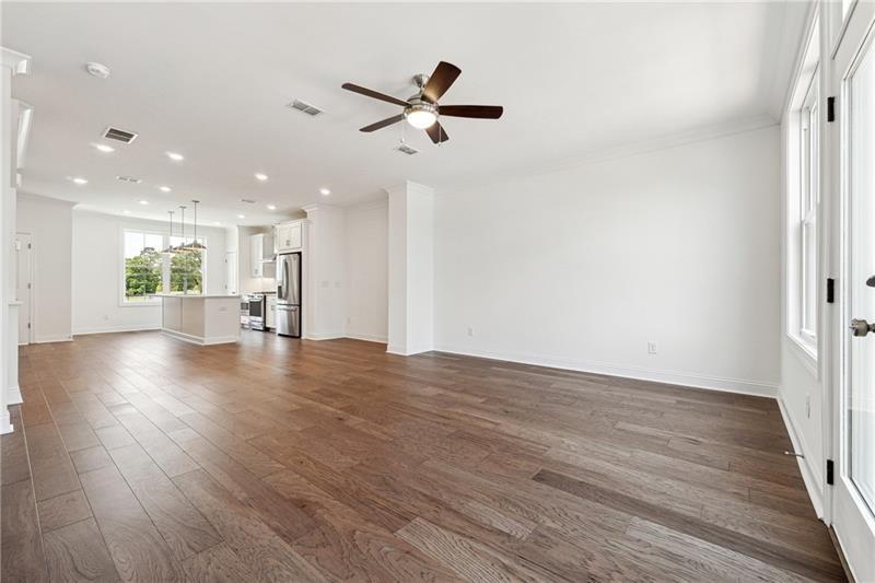 504 Healy Drive Cumming, GA 30040 - Photo 9 of 25 a view of empty room with wooden floor and window