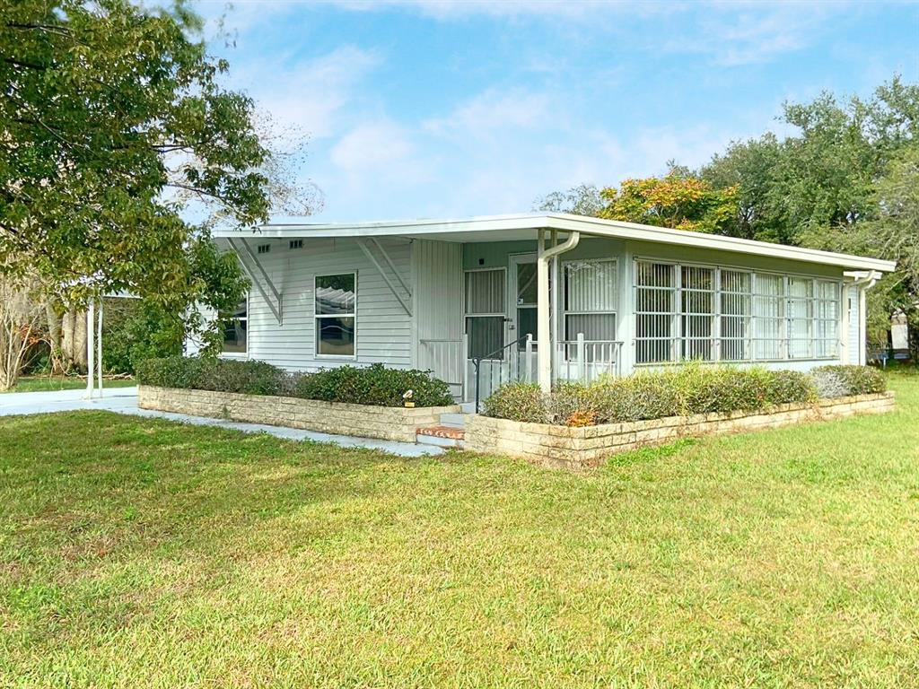 a view of a house with a swimming pool and a yard