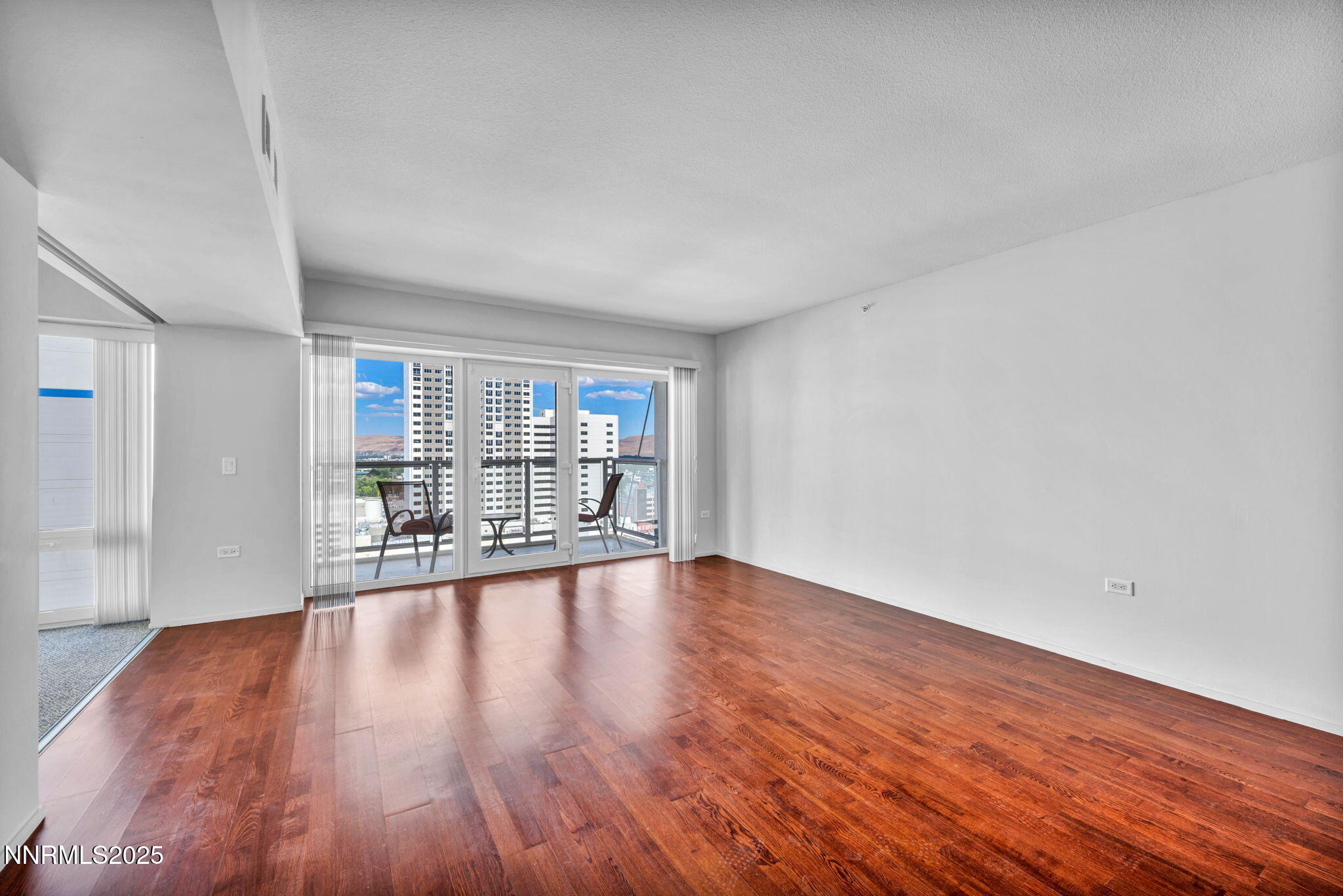 255 North Sierra Street, Unit 1908 Reno, NV 89501 - Photo 15 of 55 a view of an empty room with wooden floor and a window