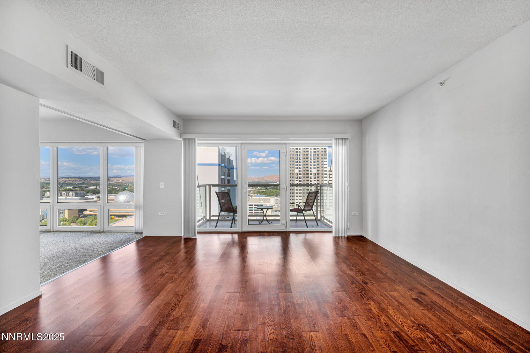 255 North Sierra Street, Unit 1908 Reno, NV 89501 - Photo 16 of 55 a view of an empty room with wooden floor and a window