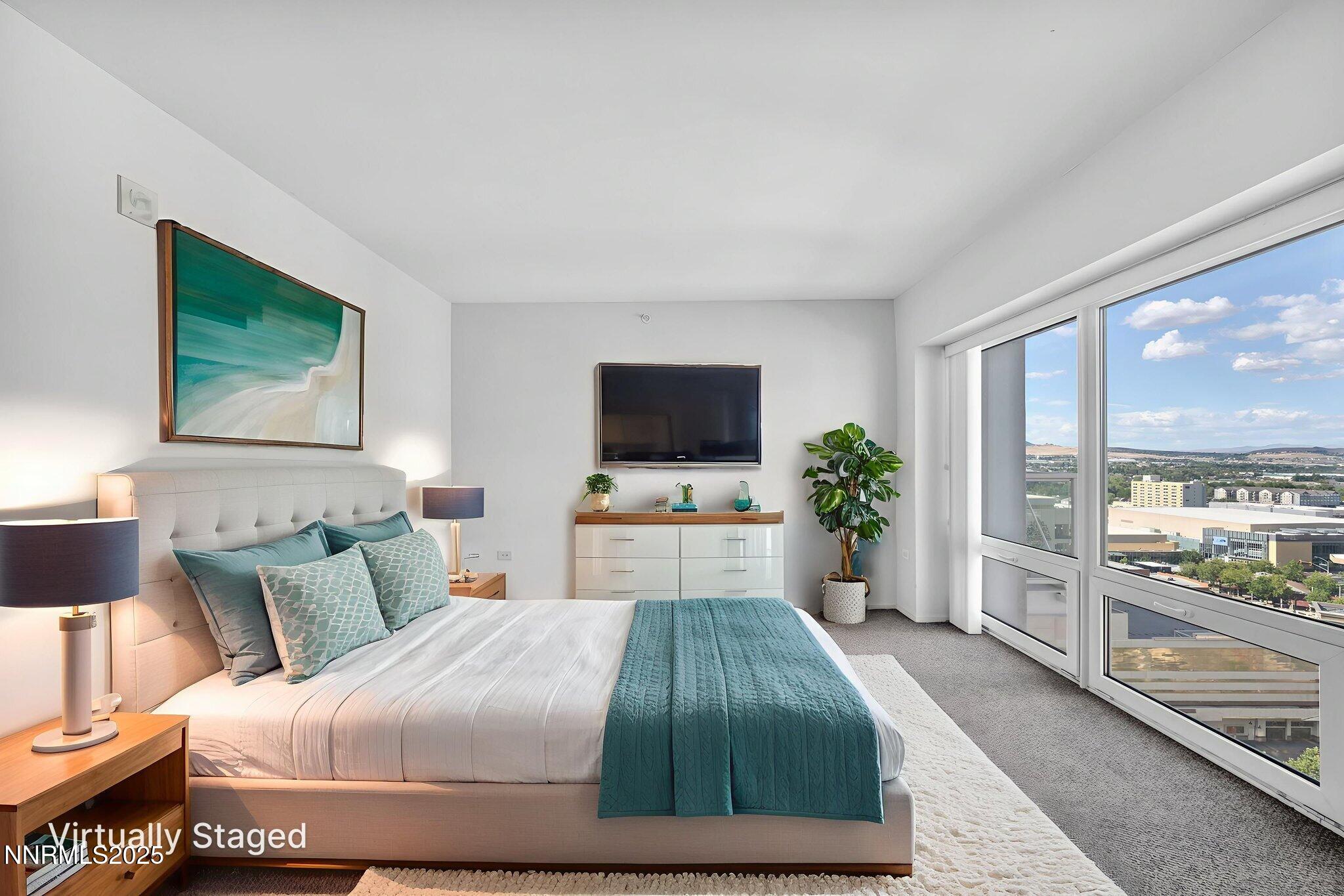255 North Sierra Street, Unit 1908 Reno, NV 89501 - Photo 30 of 55 a bedroom with a large bed and a flat screen tv