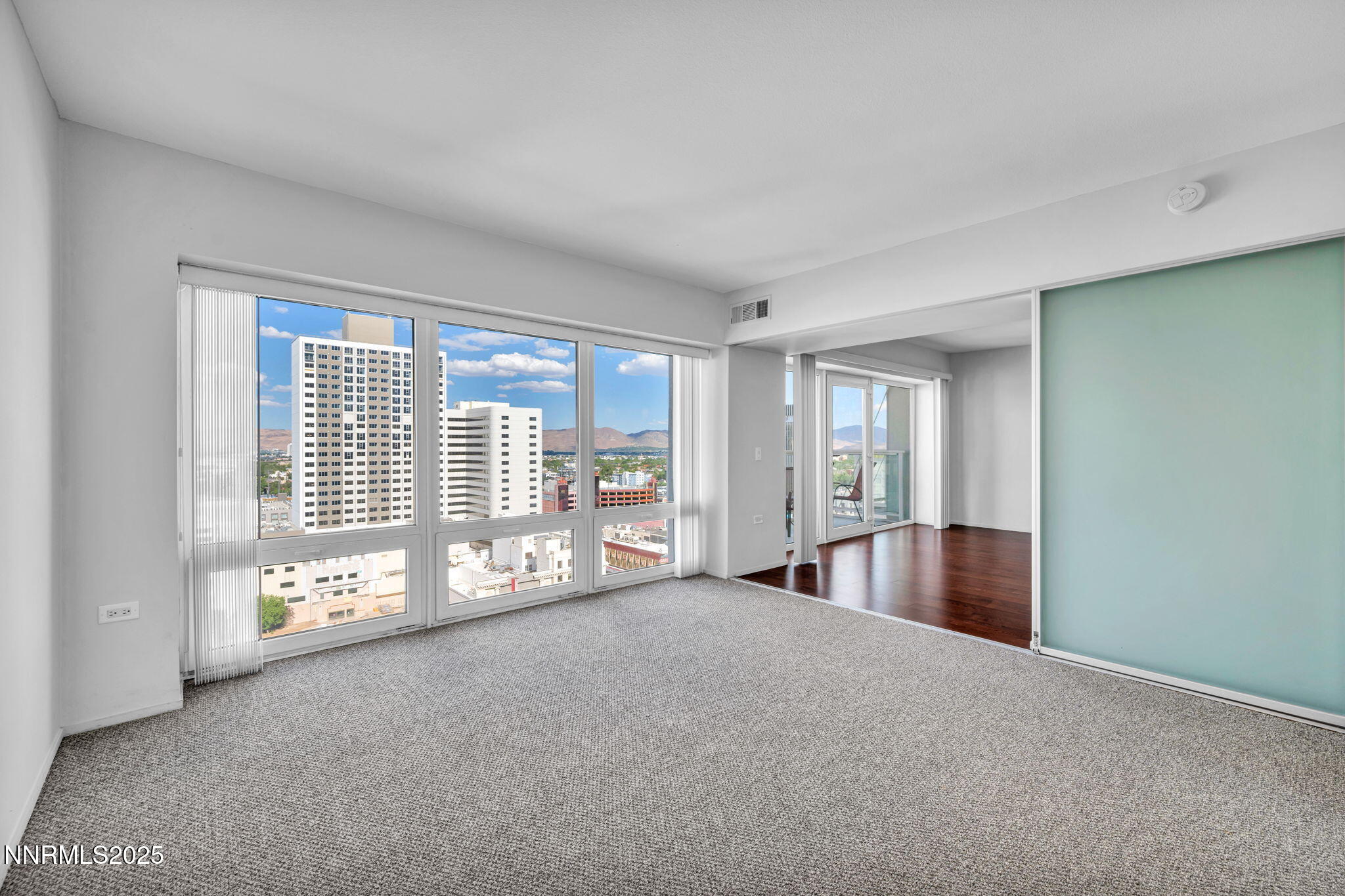 255 North Sierra Street, Unit 1908 Reno, NV 89501 - Photo 33 of 55 a view of an empty room with a fireplace and a large window