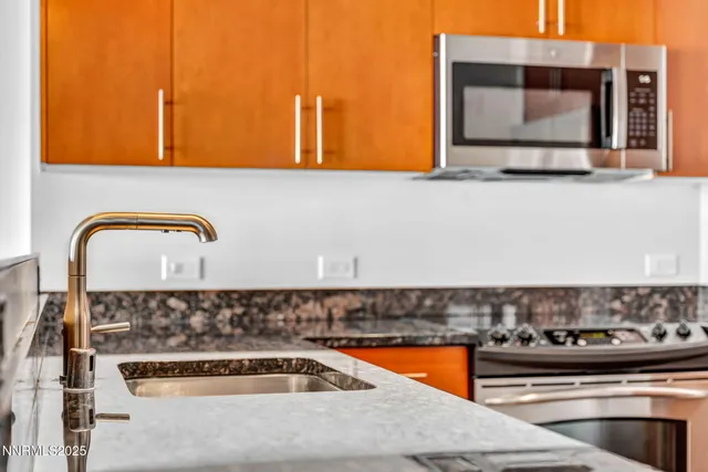 a bathroom with a granite countertop sink and a stove