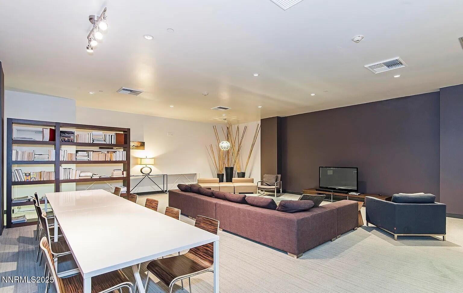 255 North Sierra Street, Unit 1908 Reno, NV 89501 - Photo 52 of 55 a living room with furniture a rug and a bookshelf