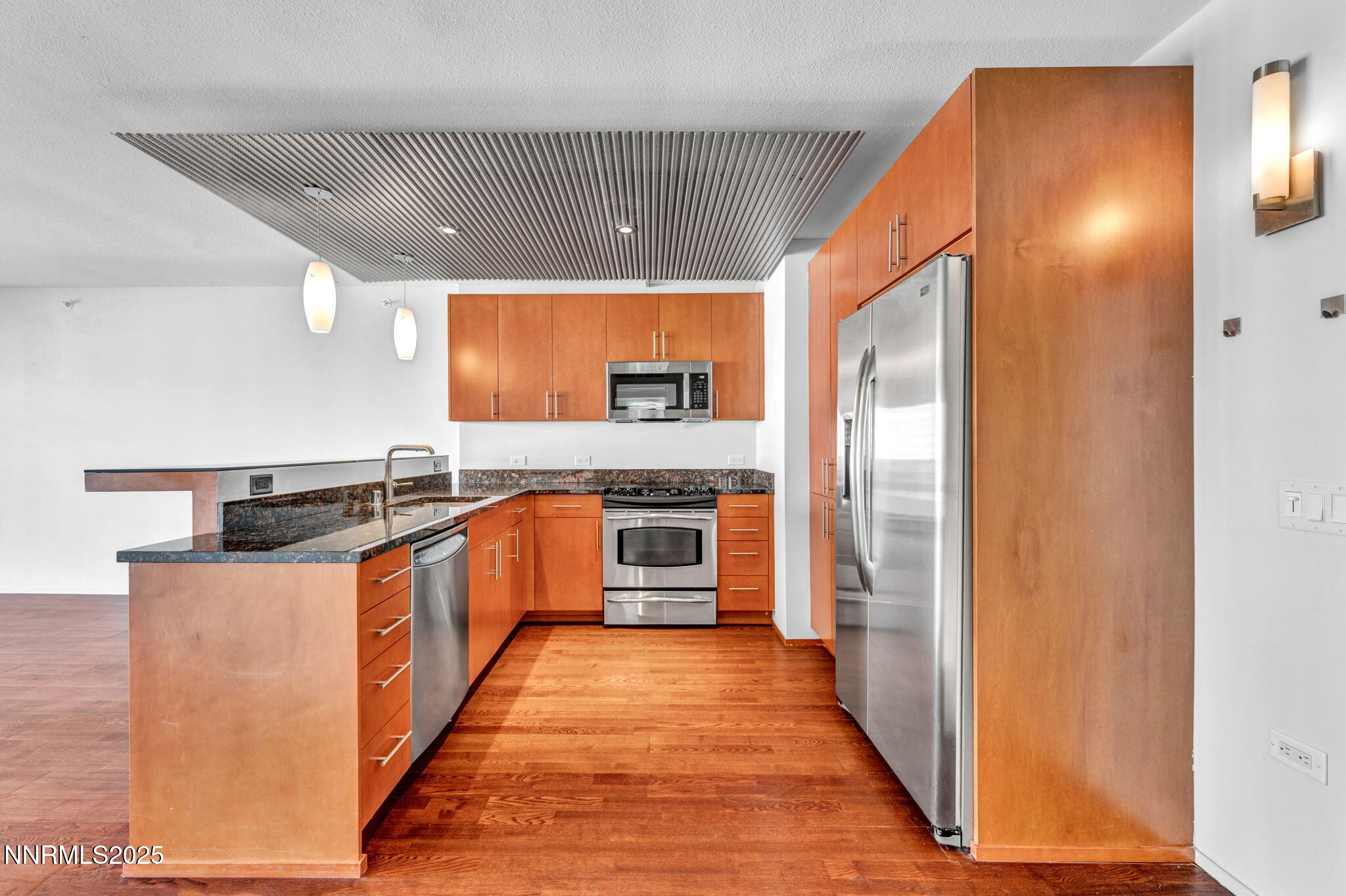255 North Sierra Street, Unit 1908 Reno, NV 89501 - Photo 8 of 55 a large kitchen with stainless steel appliances granite countertop a stove and a refrigerator