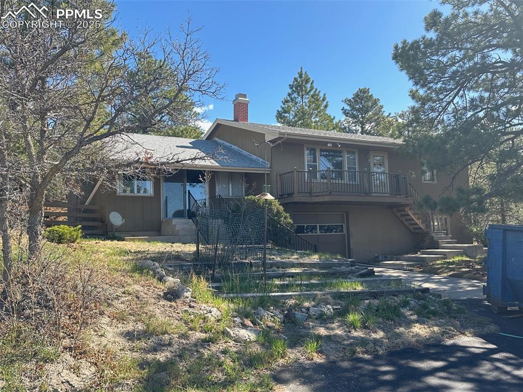 14165 Roller Coaster Road Colorado Springs, CO 80921 - Photo 1 of 12 a front view of a house with garden