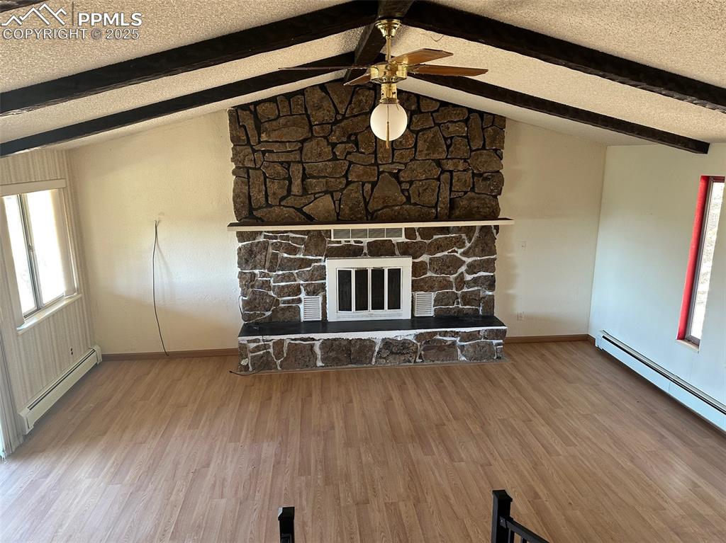14165 Roller Coaster Road Colorado Springs, CO 80921 - Photo 8 of 12 a view of an empty room with wooden floor